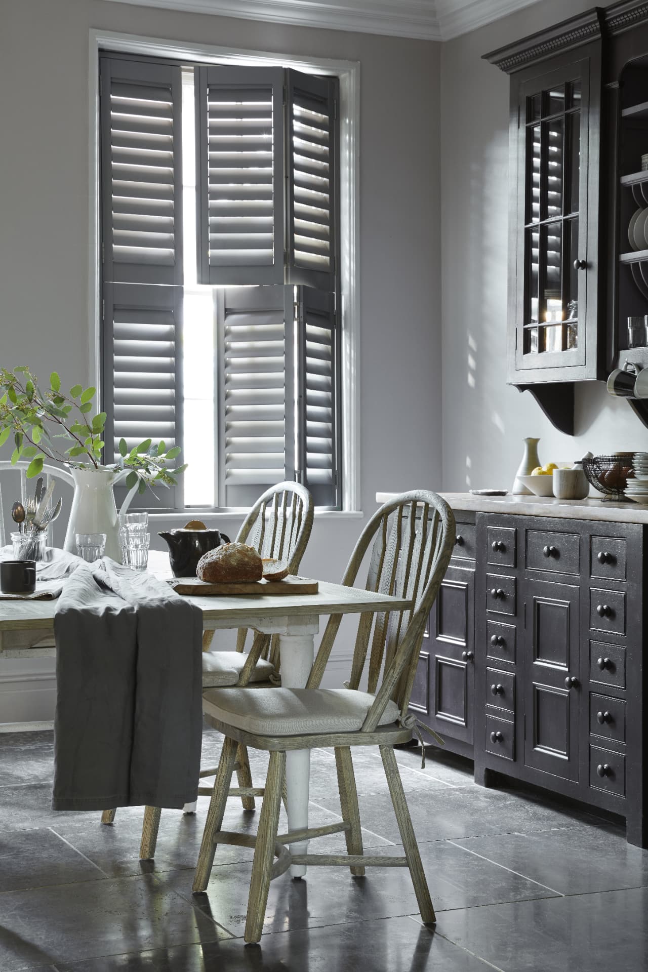 Tier-on-tier shutters with the top tier open above a kitchen table