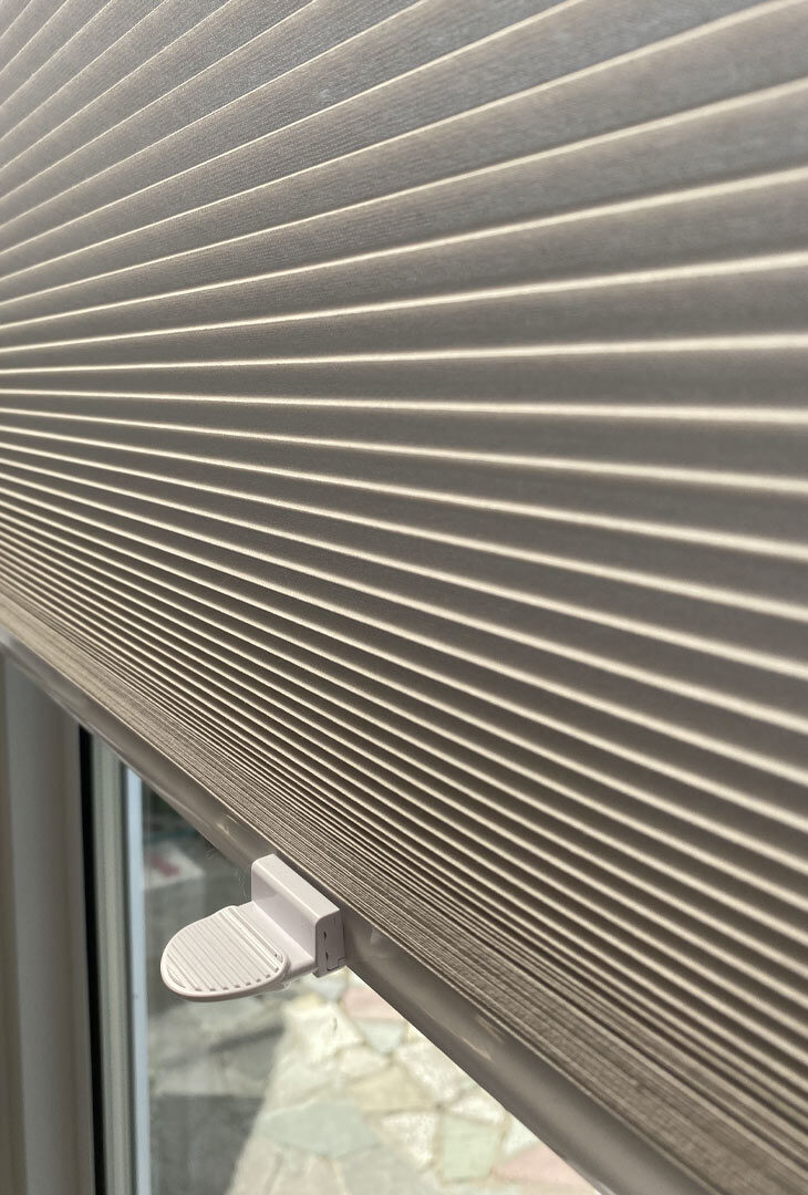 Close-up of a honeycomb pleated blind at a window