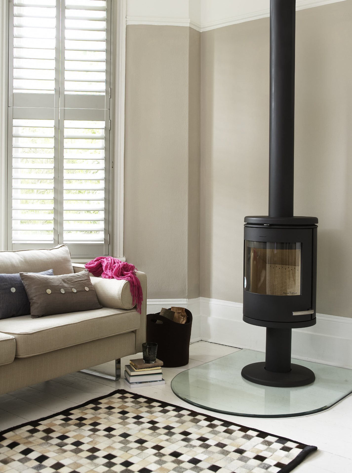 Lounge with a wood burning stove and tier-on-tier shutters