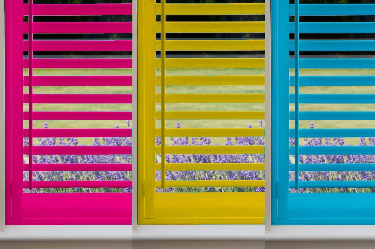 Shutters painted in bright pink, yellow and blue custom colours